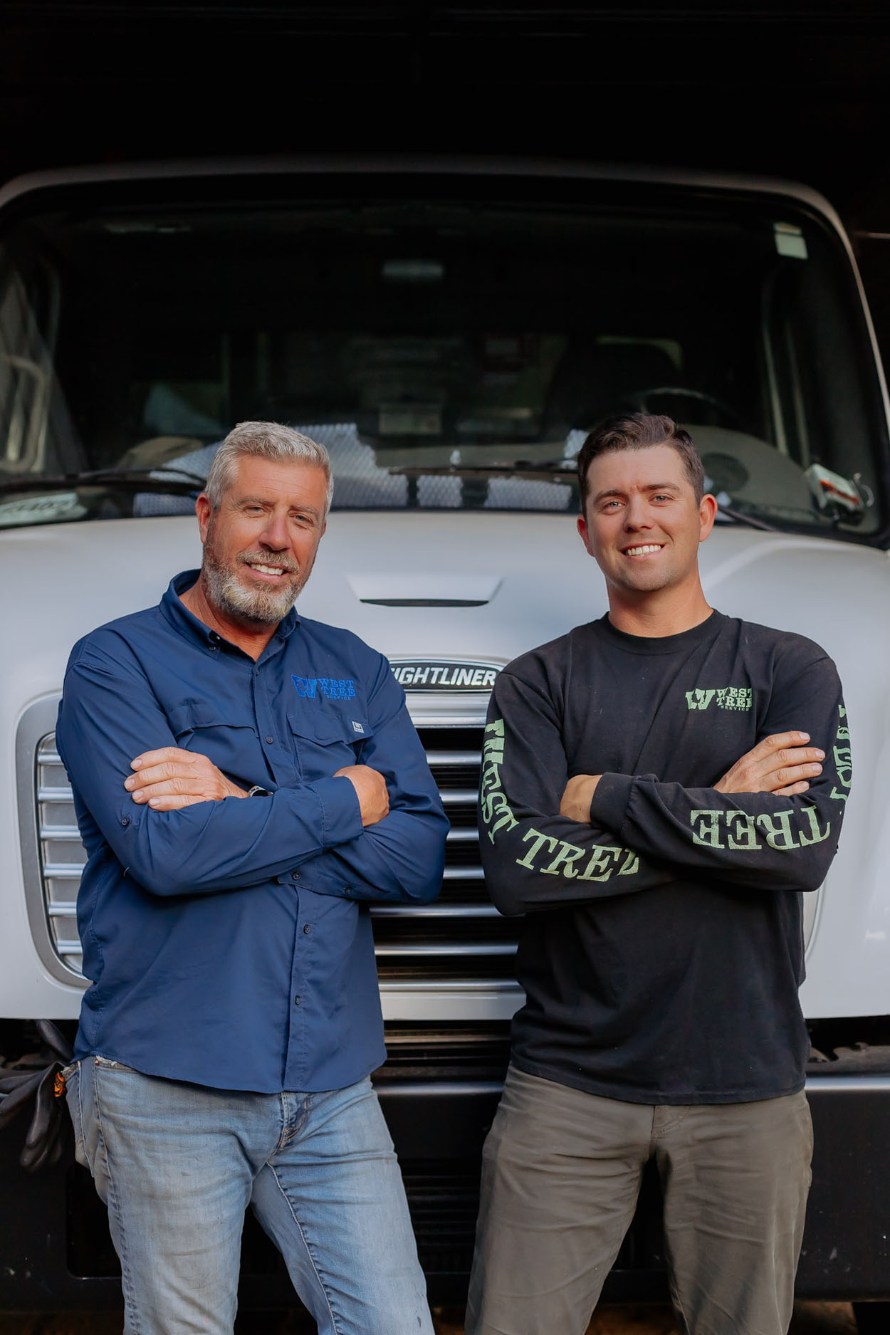 West Tree Service team members beside company equipment